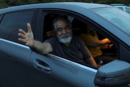 Journalist Mehmet Altan waves to media after being released from the prison in Silivri, near Istanbul, Turkey, June 27, 2018. REUTERS/Huseyin Aldemir