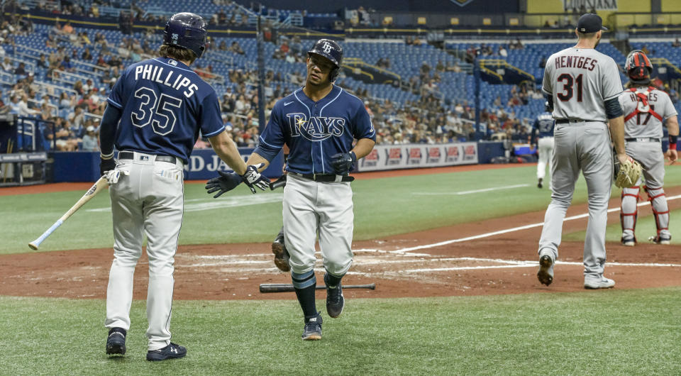 Tampa Bay Rays' Brett Phillips (35) congratulates Francisco Mejia scores on Taylor Walls RBI-single off Cleveland Indians starter Sam Hentges (31) during the second inning in the second baseball game of a doubleheader Wednesday, July 7, 2021, in St. Petersburg, Fla.(AP Photo/Steve Nesius)