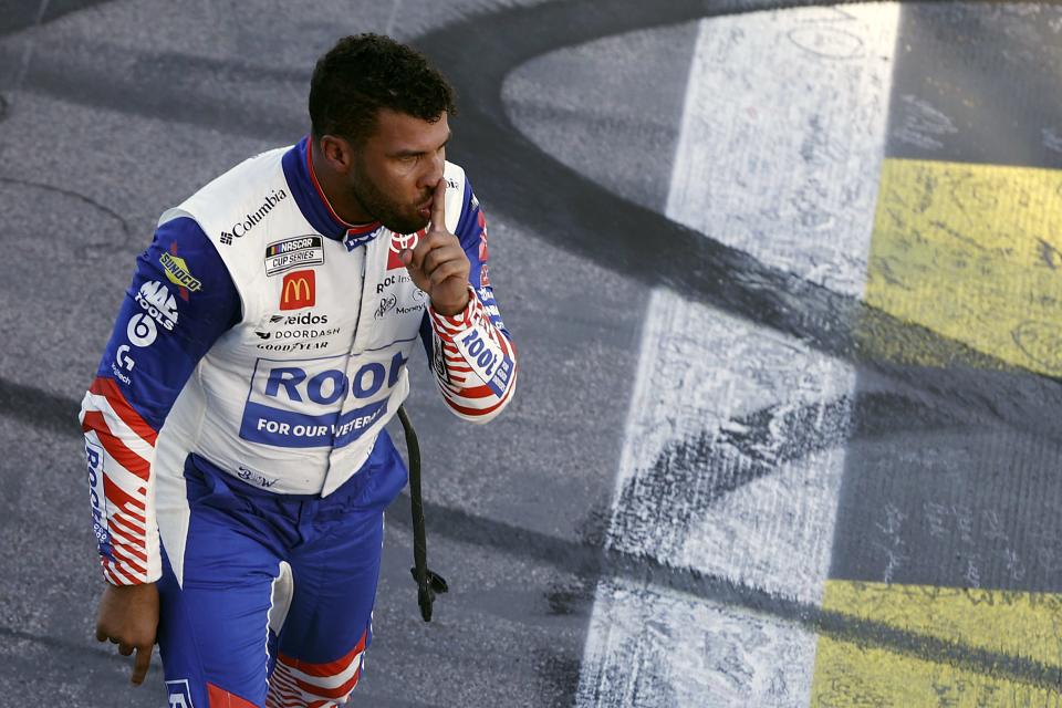 KANSAS CITY, KANSAS - SEPTEMBER 11: Bubba Wallace, driver of the #45 ROOT Insurance Toyota, gestures to the camera after winning the NASCAR Cup Series Hollywood Casino 400 at Kansas Speedway on September 11, 2022 in Kansas City, Kansas. (Photo by Meg Oliphant/Getty Images) | Getty Images