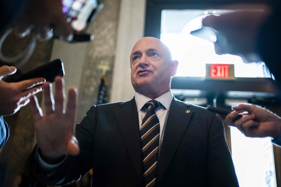 Sen. Mark Kelly, D-Ariz., talks with reporters in the Capitol on July 27.  (Tom Williams / CQ Roll Call via AP)