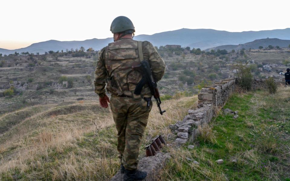 An Azeri soldier stands in the city of Jabrayil, where Azeri forces regained control during the fighting with Armenia over the breakaway region of Nagorno-Karabakh on October 16, 2020. - AFP