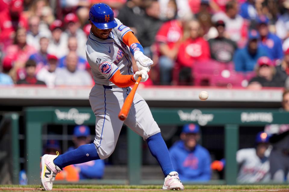 New York Mets shortstop Francisco Lindor (12) hits a double in the first inning of an MLB baseball game against the Cincinnati Reds, Sunday, April 7, 2024, at Great American Ball Park on April 7, 2024, in Cincinnati.