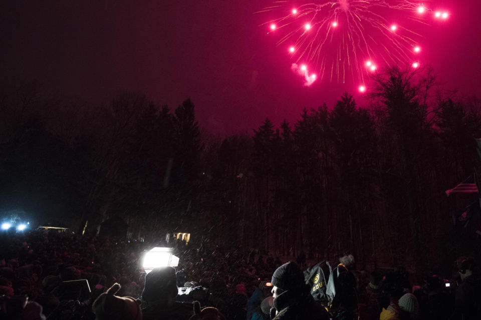 <p>Television newspeople speak on camera as fireworks explode over the tree line during ceremonies for Groundhog Day on Feb. 2, 2018 in Punxsutawney, Pa. (Photo: Brett Carlsen/Getty Images) </p>