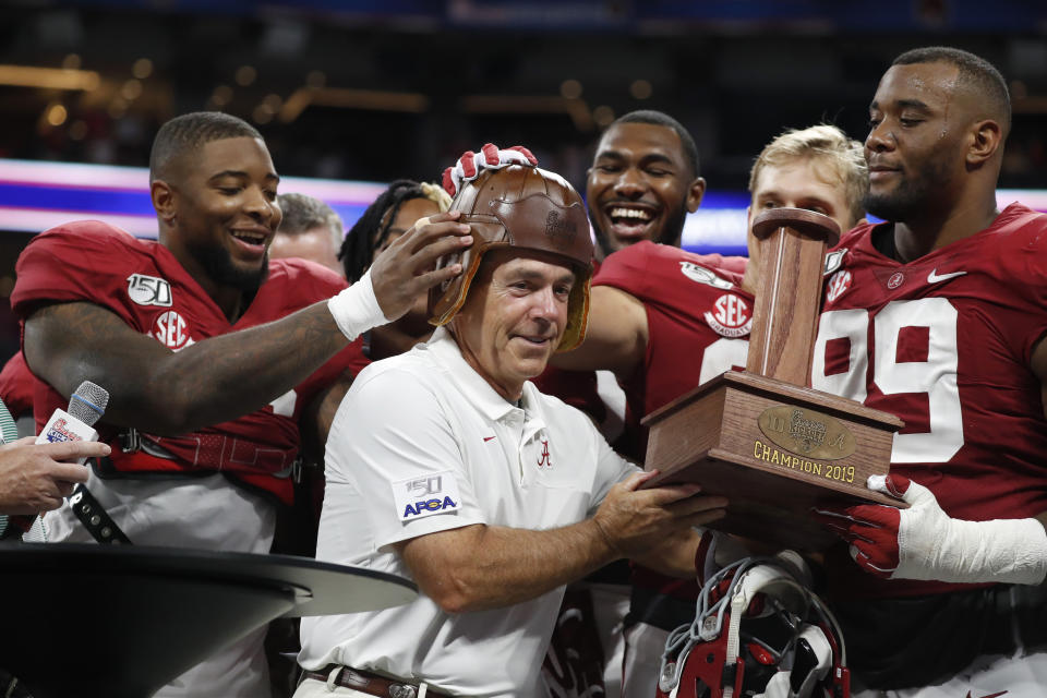 Alabama players put the "Old Leather Helmet" on head coach Nick Saban after defeating Duke 42-3 in the Chick-fil-A Kickoff NCAA college football, Saturday, Aug. 31, 2019, in Atlanta. (AP Photo/John Bazemore)