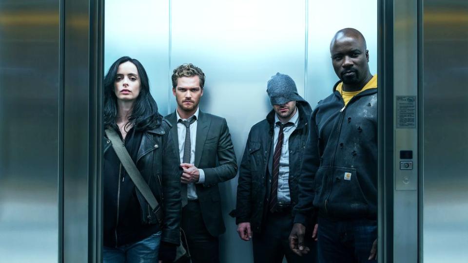 The Defenders riding in an elevator.