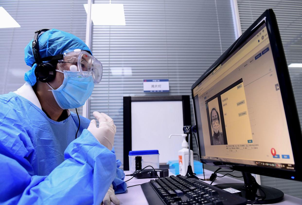 A doctor speaks with a patient during an online consultation session at a hospital in Shenyang in China's northeastern Liaoning province on February 4, 2020, amid an outbreak of a deadly SARS-like virus which began in the city of Wuhan. - The hospital provides the free online service to relieve the stress of face-to-face outpatient services and to avoid cross infection. The number of total infections in China's coronavirus outbreak has passed 20,400 nationwide with 3,235 new cases confirmed, the National Health Commission said on February 4. (Photo by STR / AFP) / China OUT (Photo by STR/AFP via Getty Images)