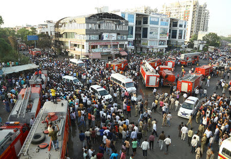 Fire trucks and ambulances are seen after a fire broke out in a four-story commercial building in Surat, in the western state of Gujarat, India, May 23, 2019. REUTERS/Stringer