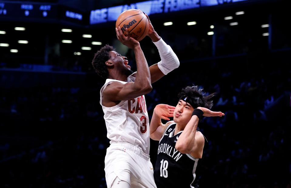 Cleveland Cavaliers guard Caris LeVert shoots over Brooklyn Nets forward Yuta Watanabe during the first half, Tuesday, March 21, 2023, in New York.