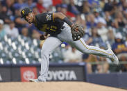 Pittsburgh Pirates third baseman Ke'Bryan Hayes bobbles a ball hit by Milwaukee Brewers' Lorenzo Cain during the third inning of a baseball game Monday, Aug. 2, 2021, in Milwaukee. (AP Photo/Jeffrey Phelps)