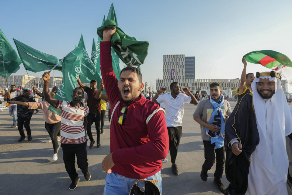 Fans of Saudi Arabia celebrate their team's 2-1 victory over Argentina in a World Cup group C soccer match, outside the Lusail Stadium in Lusail Qatar, Tuesday, Nov. 22, 2022. (AP Photo/Andre Penner)