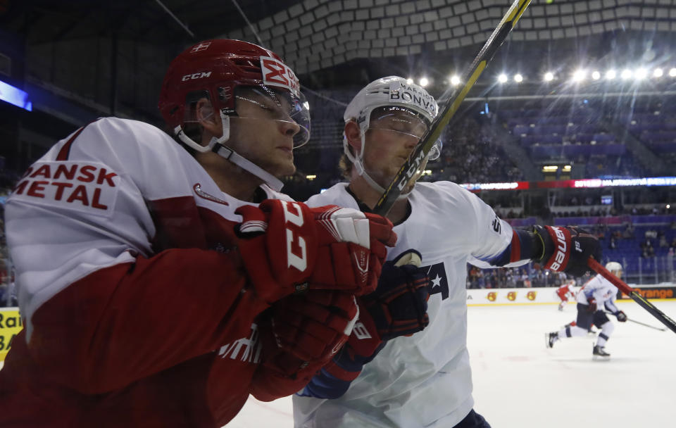 Jack Eichel of the US, right, checks Denmark's Oliver Larsen, left, during the Ice Hockey World Championships group A match between Denmark and the United States at the Steel Arena in Kosice, Slovakia, Saturday, May 18, 2019. (AP Photo/Petr David Josek)