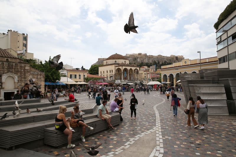 People make their way around Monastiraki square in Athens