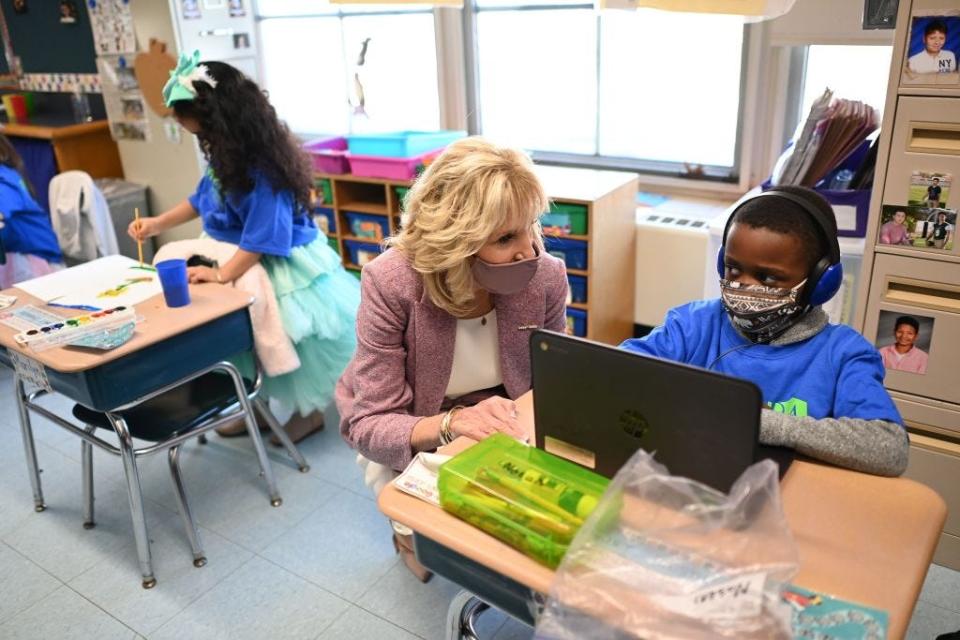 First lady Jill Biden speaks with a student as she tours Benjamin Franklin Elementary School in Meriden, Conn., on March 3, 2021. She was visiting to help reassure school districts they can reopen safely during the pandemic.