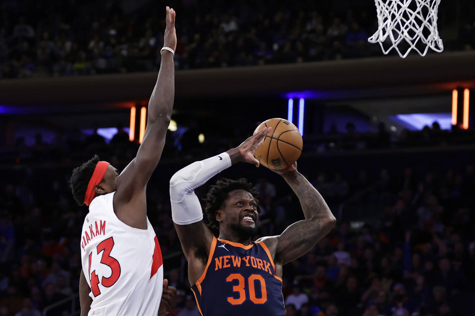 New York Knicks forward Julius Randle (30) drives to the basket past Toronto Raptors forward Pascal Siakam during the second half of an NBA basketball game Monday, Jan. 16, 2023, in New York. (AP Photo/Adam Hunger)