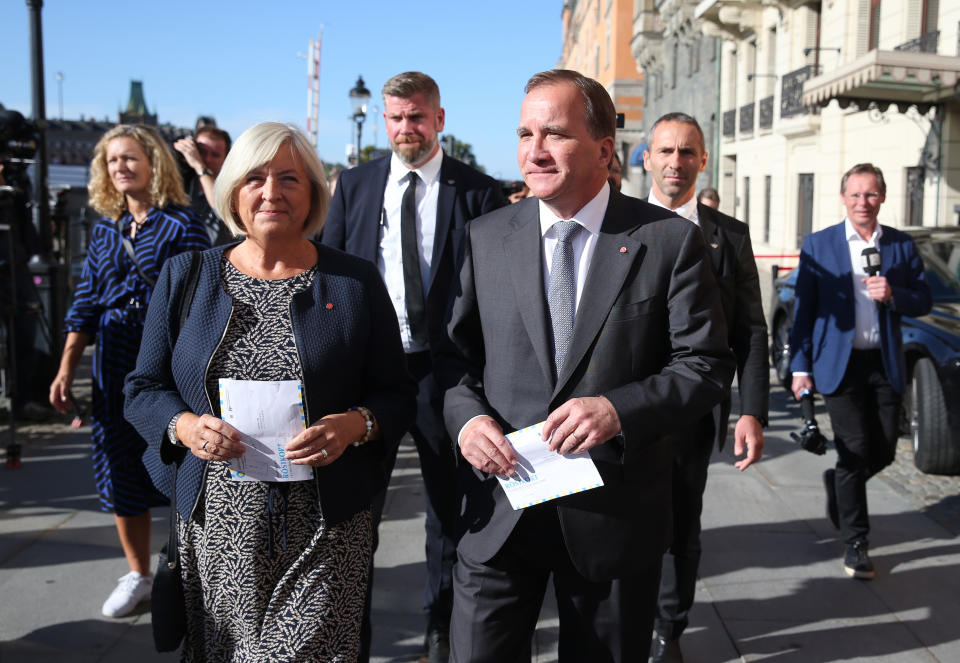 Stefan Lofven, leader of the Social Democratic Party and prime minister of Sweden, right, arrives with his wife Ulla to cast their votes in Stockholm, Sweden, Sunday Sept. 9, 2018. Polls have opened in Sweden's general election in what is expected to be one of the most unpredictable and thrilling political races in Scandinavian country for decades amid heated discussion around top issue immigration. (Soren Andersson/TT via AP)