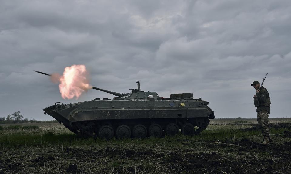 FILE - A Ukrainian APC fires towards Russian positions near Avdiivka, in the Donetsk region, Ukraine, Friday, April 28, 2023. A dayslong attempt by Russian forces to storm a strategically important city in eastern Ukraine appears to be running out of steam, Kyiv officials claimed Monday, Oct. 16, 2023 as the Kremlin’s war entered its 600th day. (AP Photo/Libkos, File)