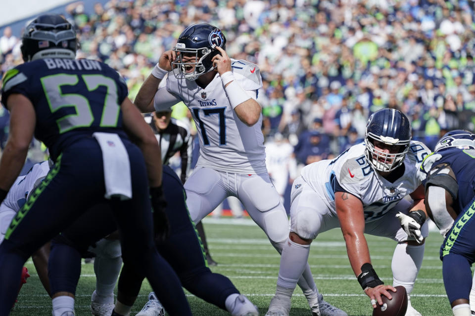 Tennessee Titans quarterback Ryan Tannehill calls to his team as he lines up under center Ben Jones (60) during the second half of an NFL football game against the Seattle Seahawks, Sunday, Sept. 19, 2021, in Seattle. (AP Photo/Elaine Thompson)