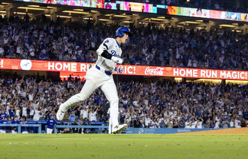 Dodgers designated player Shohei Ohtani reacts as he runs the bases after hitting a 433-foot, 2-run homer