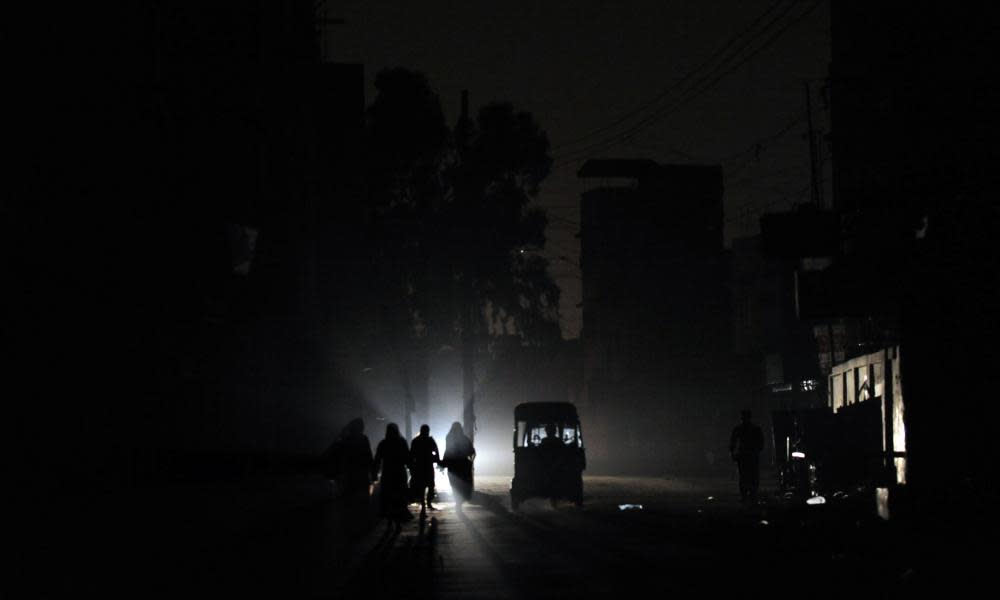 People on a street during a power cut in Karachi