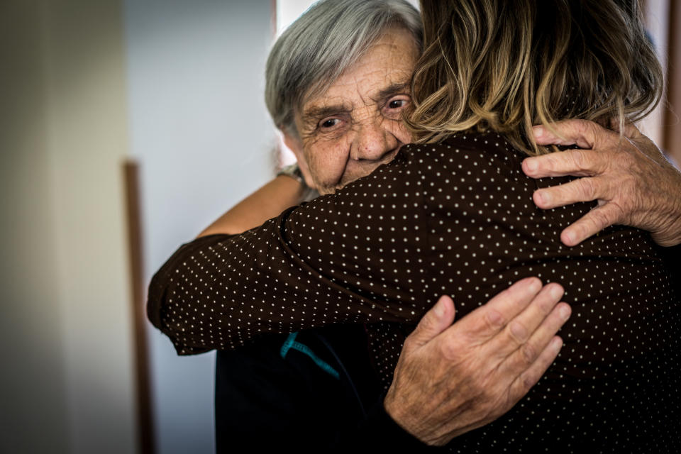 Woman hugging her elderly mother