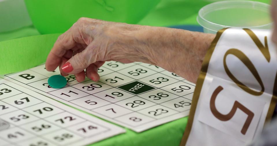 Helen Molnar plays bingo during her 105th birthday party Tuesday at The Landing of Stow.