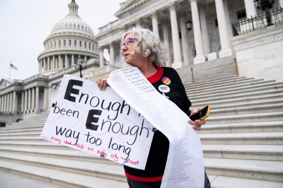 Cindy Nell of Prince Georges County, Maryland, holds a list of school shootings since 1998 during a demonstration with Moms Demand Action for Gun Sense in America on Wednesday, May 25, 2022