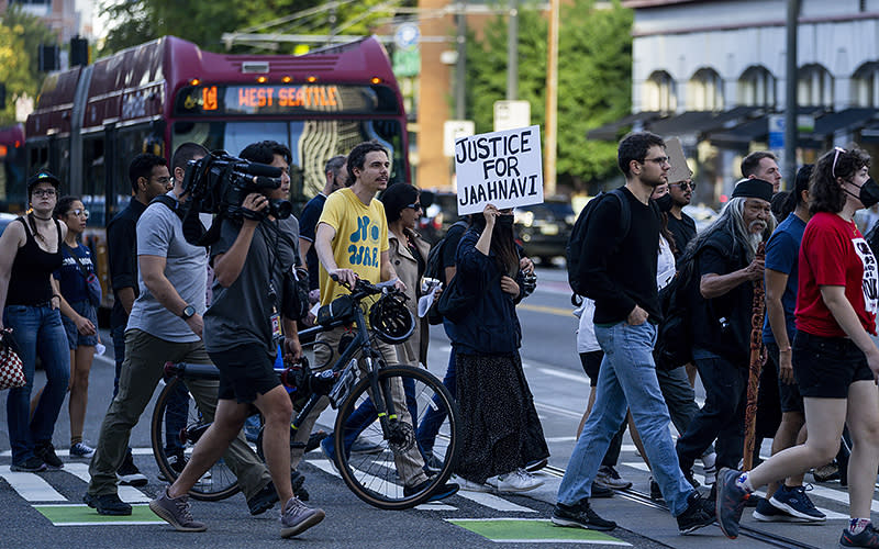 Protesters march through downtown Seattle on Sept. 14 after body camera footage was released of a Seattle police officer joking about the death of Jaahnavi Kandula, a 23-year-old woman hit and killed in January by officer Kevin Dave in a police cruiser. <em>Associated Press/Lindsey Wasson</em>