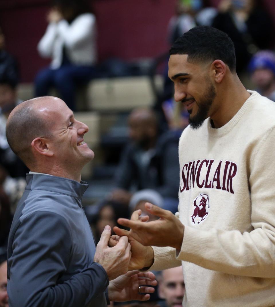 New York Knicks star, and former Ossining High School basketball player Obi Toppin greets his former coach Mike Casey during a ceremony retiring his number in the Ossining High School gym Feb. 3, 2023. 