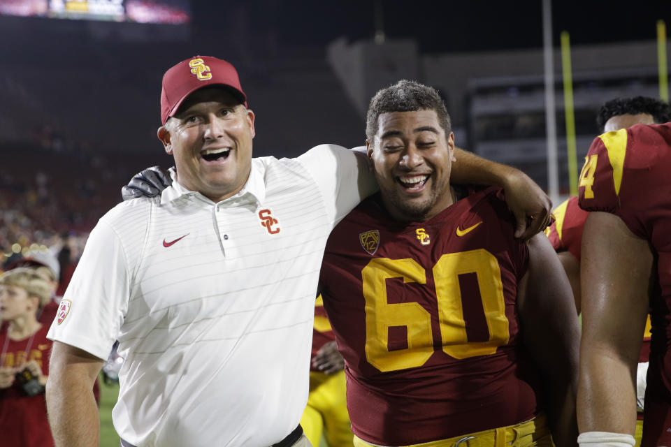 Southern California head coach Clay Helton, left, and Viane Talamaivao celebrate the team’s 42-24 win against Stanford as they walk off the field after an NCAA college football game, Saturday, Sept. 9, 2017, in Los Angeles. (AP Photo/Jae C. Hong)