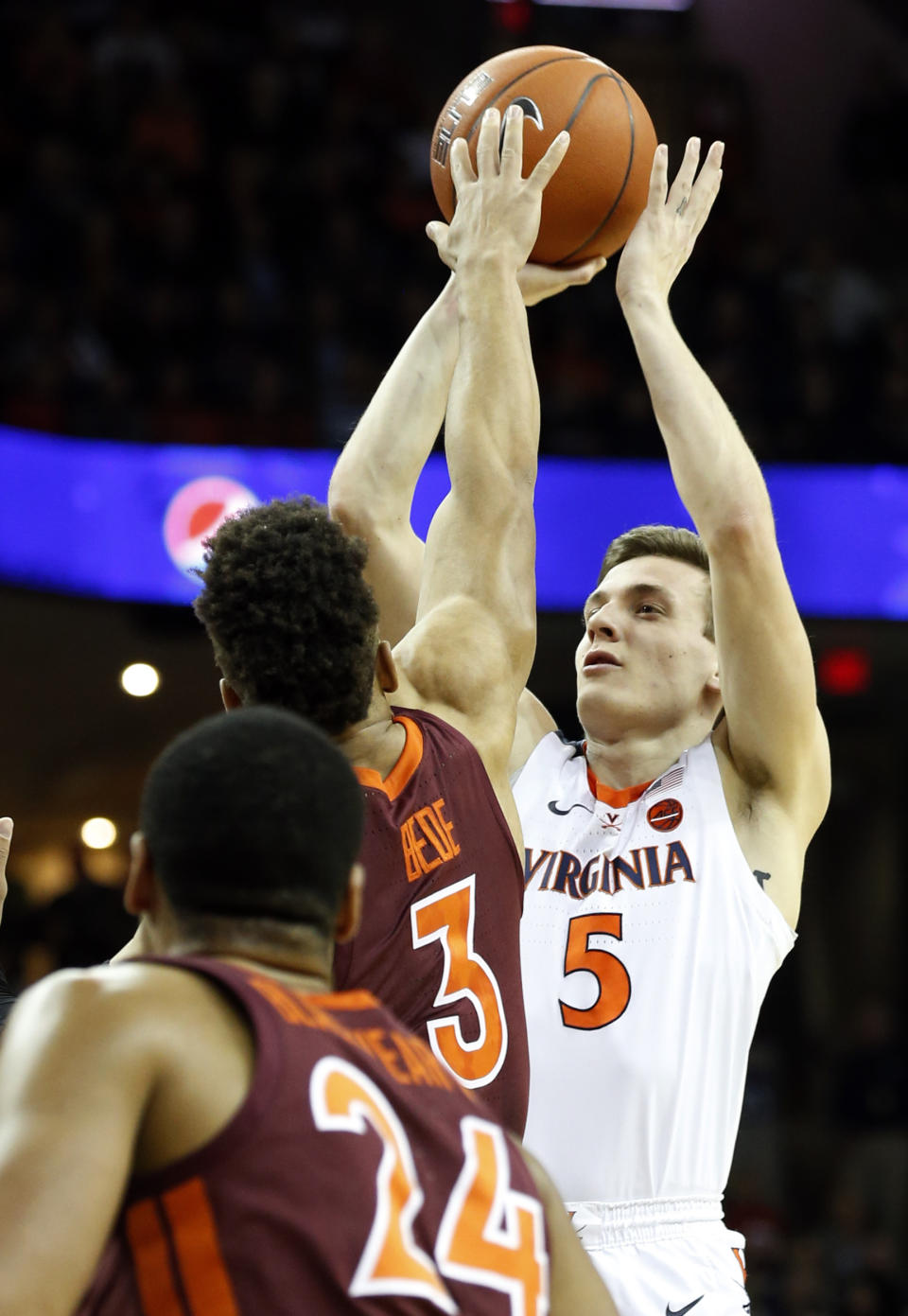 Virginia guard Kyle Guy (5) takes a shot over Virginia Tech guard Wabissa Bede (3) during the first half of an NCAA college basketball game in Charlottesville, Va., Tuesday, Jan. 15, 2019. (AP Photo/Steve Helber)