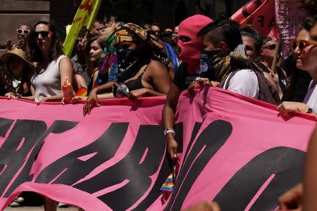 Participants take part in the LGBT Pride March in the Manhattan borough of New York City, U.S., June 25, 2017. REUTERS/Carlo Allegri