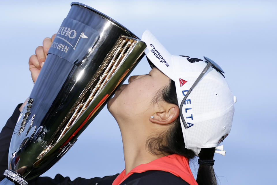 Rose Zhang kisses the trophy after winning the Mizuho Americas Open golf tournament, Sunday, June 4, 2023, in Jersey City, N.J. (AP Photo/Adam Hunger)