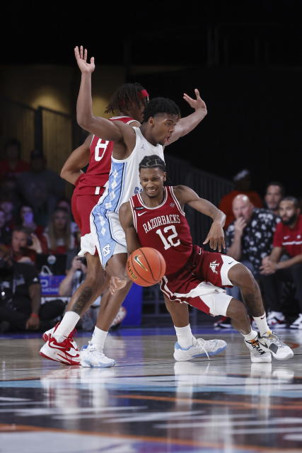 Arkansas' Tramon Mark drives the ball past North Carolina's Harrison Ingram during an NCAA college basketball game in the Battle 4 Atlantis at Paradise Island, Bahamas, Friday, Nov. 24, 2023. (Tim Aylen/Bahamas Visual Services via AP)