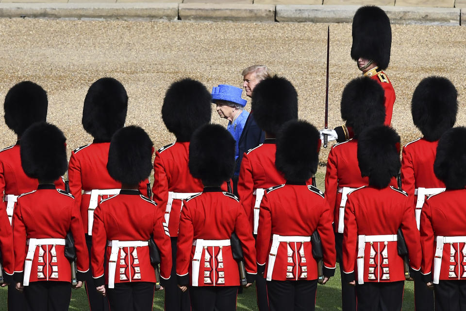 FILE - In this July 13, 2018, file photo, Britain's Queen Elizabeth II and President Donald Trump inspect the Guard of Honour, at Windsor Castle, in Windsor, England. Like a bull who keeps going back to the china shop, Trump is returning to Europe. (Ben Stansall/Pool Photo via AP)