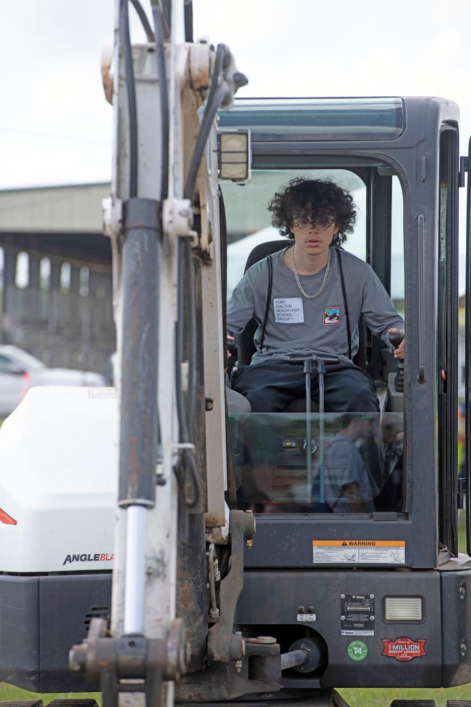 High school student Ryan Reed learns how to operate construction equipment during the third annual Construction Career Days event in Santa Rosa County on Wednesday, April 26, 2023. Students from Santa Rosa, Escambia and Okaloosa counties participated in the annual career fair.