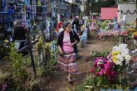 <p>A man adorns a grave at the municipal cemetery of Villa Nueva, 25 km south of Guatemala City, during the celebration of All Saints’ Day on Nov. 1, 2017. (Photo: Johan Ordonez/AFP/Getty Images) </p>