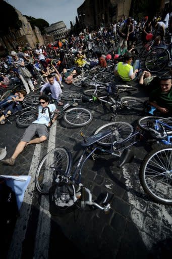 Cyclists take part in a protest rally calling for more and safer bicycle infrastructure, in Rome. Protesters lay down in memory of slain cyclists on the Via dei Fori Imperiali built by fascist dictator Benito Mussolini through the Roman Forum, calling for the busy thoroughfare in Rome's historic centre to be pedestrianised