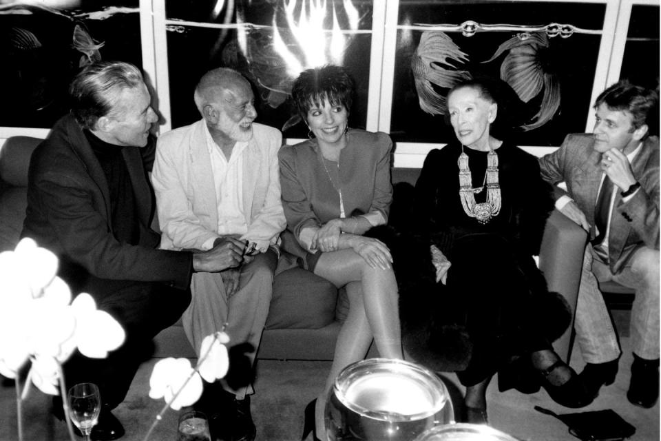 <p>In 1987, designer Halston hosted the Benefit for the Martha Graham School of Contemporary Dance at his home. Here, he (far left) is pictured with Jerry Robbins, Liza Minnelli, Martha Graham, and Mikhail Baryshnikov (left to right). See his apartment, featured in <em>House Beautiful </em>in 1977, <a href="https://www.housebeautiful.com/design-inspiration/a36689481/halston-manhattan-townhouse-paul-rudolph-archive-dive-1977/" rel="nofollow noopener" target="_blank" data-ylk="slk:here.;elm:context_link;itc:0;sec:content-canvas" class="link ">here. </a></p>