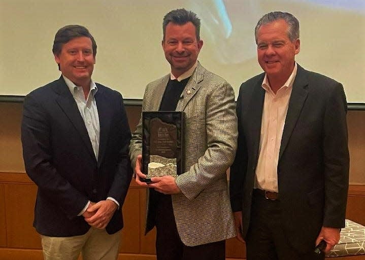 N.C. Senator-elect Tim Moffitt receives the Legislative Leadership Award from the North Carolina Beer and Wine Wholesalers Association from Association chairman Tee Nunnelee (left) and Association Executive Director Tim Kent (right).