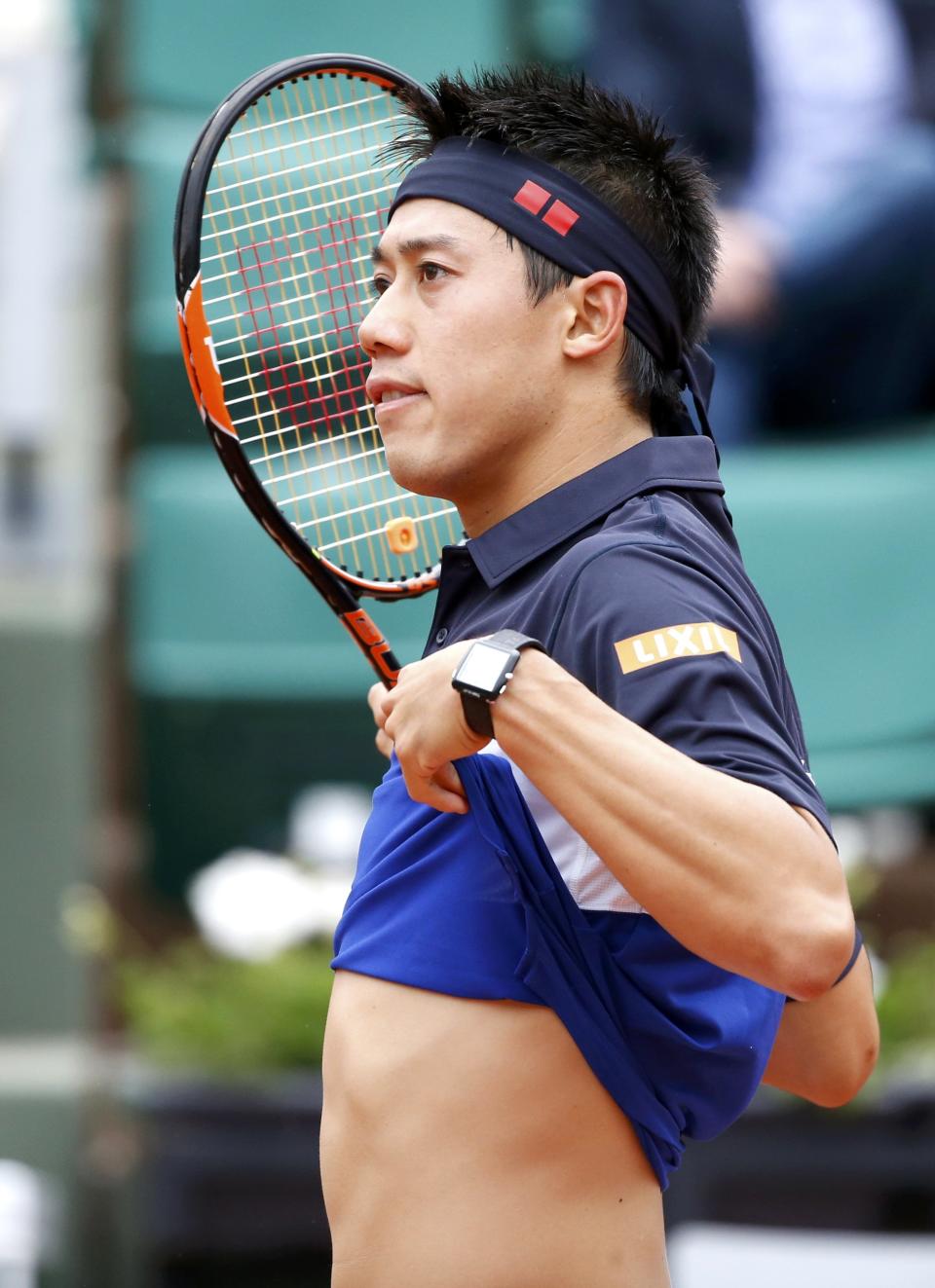 Kei Nishikori of Japan reacts during the men's singles match against Teymuraz Gabashvili of Russia at the French Open tennis tournament at the Roland Garros stadium in Paris