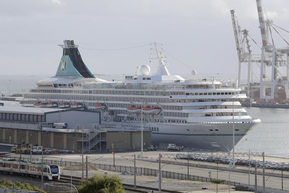 This Friday, March 27, 2020, photo shows the cruise ship Artania docked at Fremantle harbour in Fremantle, Australia. Authorities were still hoping to fly 800 cruise ship passengers from Australia to Germany on the weekend, but a sharp overnight rise in cases of the new coronavirus on board brought severe complications for the repatriation mission. (Richard Wainwright/AAP Image via AP)