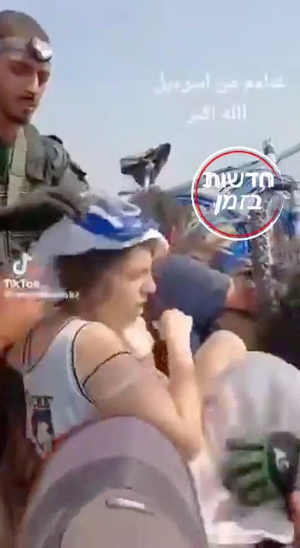 A screengrab from a social media video shows people taken hostage by Palestinian militants (via REUTERS)