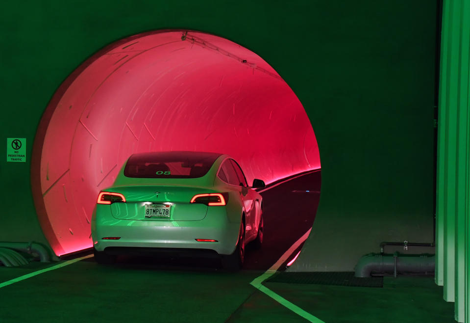 LAS VEGAS, NEVADA - APRIL 09: A Tesla car drives through a tunnel at Central Station during a media preview of the Las Vegas Convention Center on April 9, 2021 in Las Vegas, Nevada.  The Las Vegas Convention Center Loop is an underground transportation system that is the first commercial project of Elon Musk's The Boring Company.  The US$52.5 million loop, which includes two one-way vehicle tunnels 40 feet below ground and three passenger stations, will shuttle conference attendees to the 200-acre campus for free in all-electric Tesla vehicles in less than two minutes.  It can take over 25 minutes to walk this distance.  The system is designed to transport 4,400 people per hour using a fleet of 62 vehicles at maximum capacity.  It is scheduled to be fully operational in June, when the facility plans to host its first large-scale conference after the COVID-19 shutdown.  There are plans to expand the system to the entire resort corridor in the future.  (Photo by Ethan Miller/Getty Images)