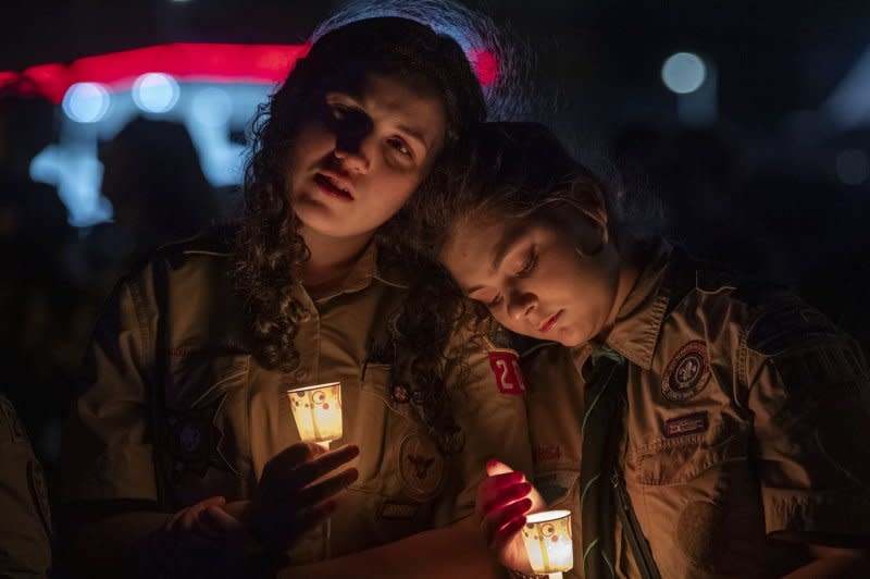 Members of the Maine Boy Scouts of America embrace during a candlelight vigil for the victims of the Lewiston Maine mass shooting at the Worumbo Riverfront in Lisbon, Maine on October 28. File photo by Amanda Sagba/EPA-EFE