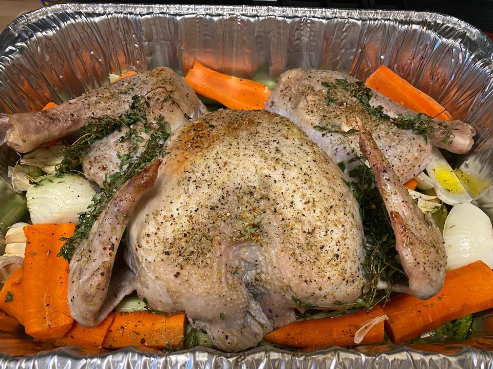 A turkey with vegetables and seasoning.