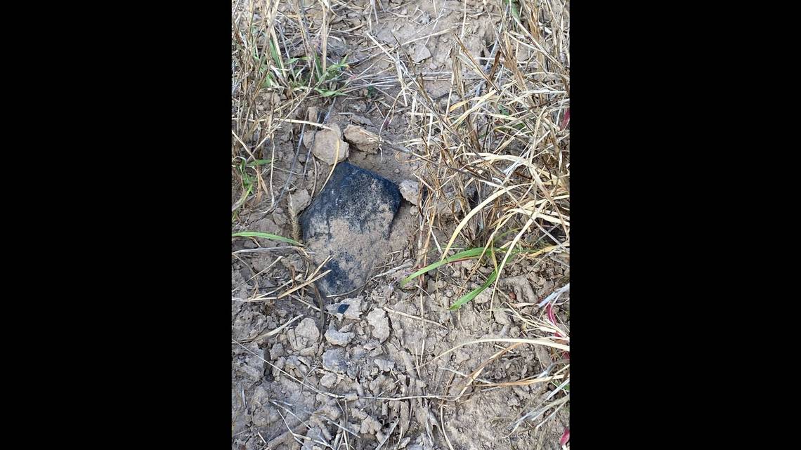 A meteorite found partially embedded in the ground near El Sauz, Texas. Phil Mani.