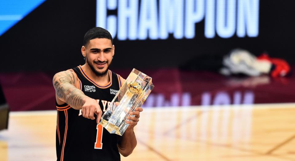 New York Knicks forward Obi Toppin (1) celebrates with the trophy after winning the AT&amp;T slam dunk contest during the 2022 NBA All-Star Saturday Night at Rocket Mortgage Field House.