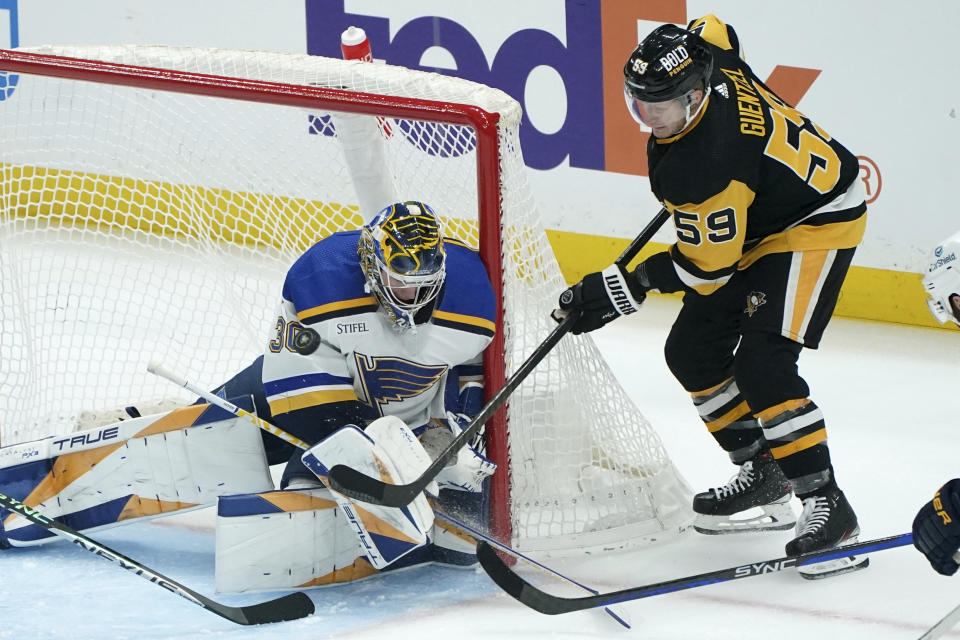 St. Louis Blues goaltender Joel Hofer (30) stops a shot by Pittsburgh Penguins' Jake Guentzel (59) during the first period of an NHL hockey game Saturday, Dec. 30, 2023, in Pittsburgh. (AP Photo/Matt Freed)