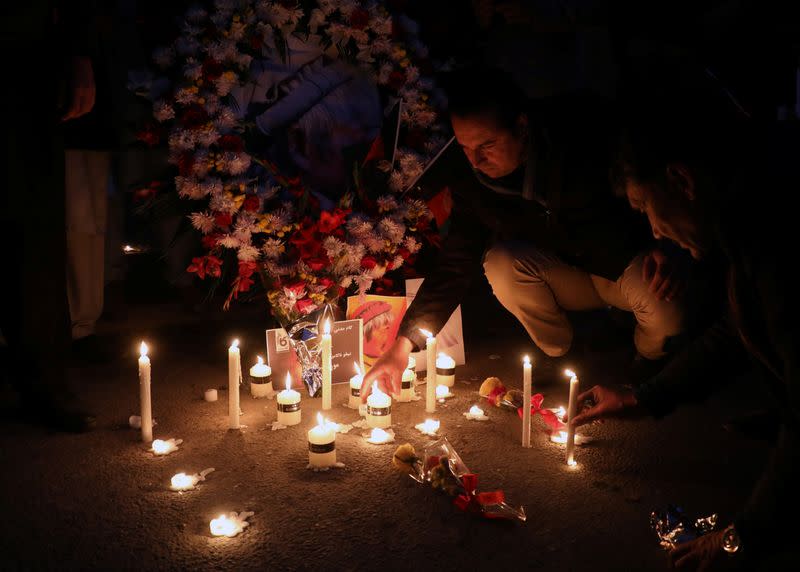 Afghan men light candles for Japanese doctor Tetsu Nakamura, who was killed in Jalalabad in yesterday's attack, in Kabul