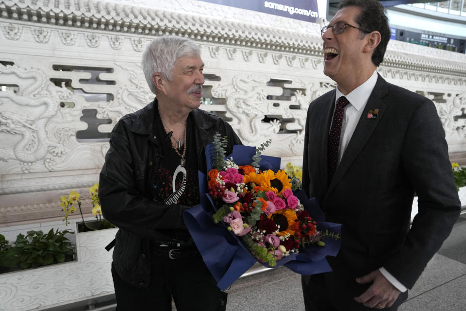 Philadelphia Orchestra's 73-year-old violinist Davyd Booth, left, chats with Ryan Fleur, Executive Director with The Philadelphia Orchestra, at the Beijing Capital International Airport on Tuesday, Nov. 7, 2023. Musicians from the Philadelphia Orchestra arrived in Beijing on Tuesday, launching a tour commemorating its historic performance in China half a century ago in signs of improving bilateral ties ahead of a highly anticipated meeting between President Joe Biden and Xi Jinping. (AP Photo/Ng Han Guan)